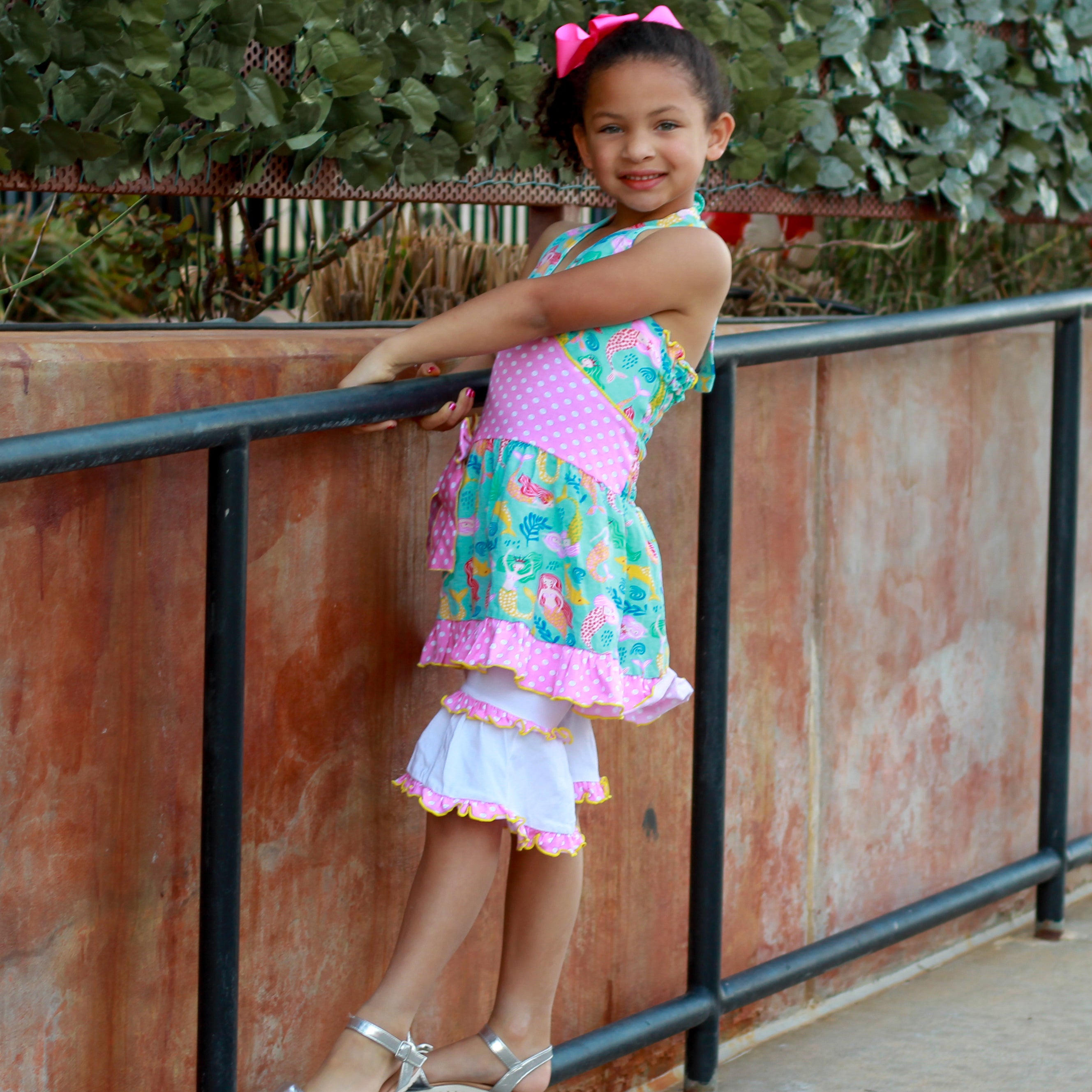 AnnLoren Girls Mermaid Halter Dress featuring a pink polka dot waistband and big bow, paired with white ruffle shorts, perfect for summer wear.